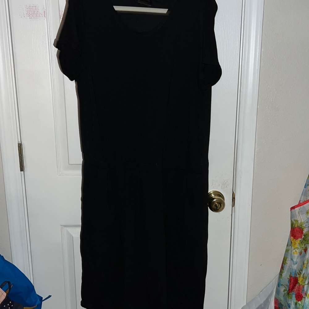 Black midi t-shirt dress with synched waist, two pockets below waist